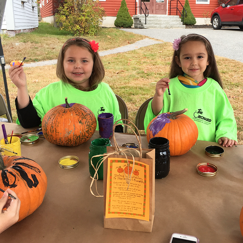 girls decorating pumpkins